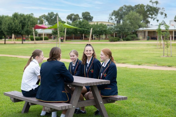 MAGS Girls sitting at a table in playground